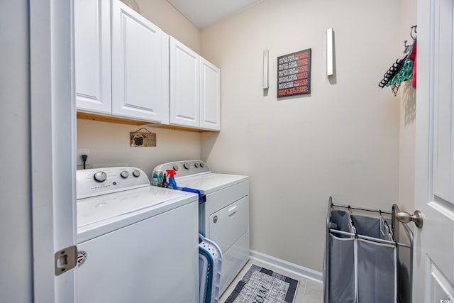 laundry room with washer and clothes dryer and cabinets