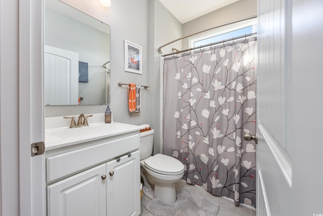 bathroom with tile patterned flooring, vanity, a shower with shower curtain, and toilet