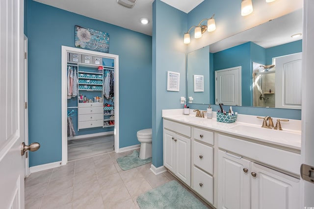 bathroom featuring vanity, an enclosed shower, tile patterned floors, and toilet