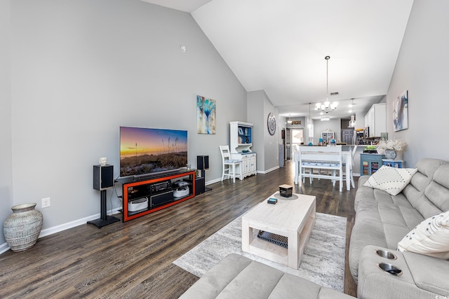 living room featuring high vaulted ceiling, a notable chandelier, and dark hardwood / wood-style flooring