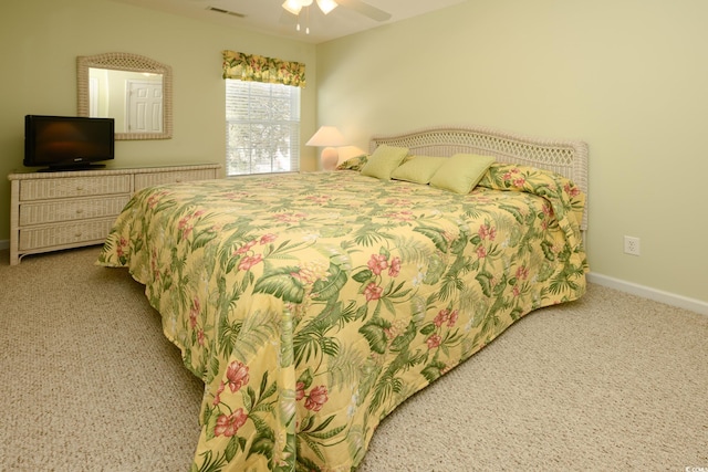 carpeted bedroom with baseboards, visible vents, and ceiling fan