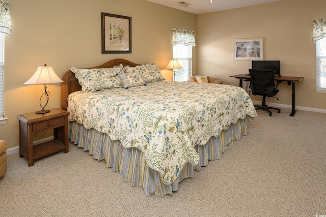 bedroom with carpet floors and baseboards