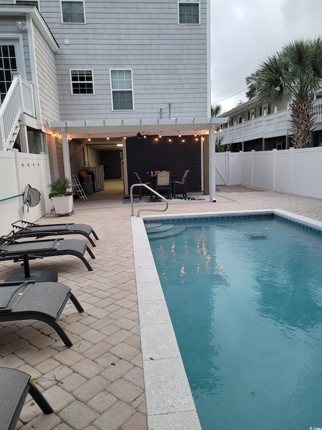 view of swimming pool featuring a fenced in pool, a patio, and fence