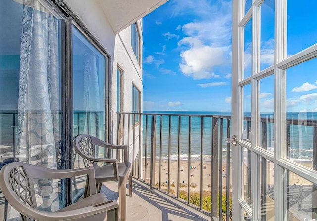 balcony with a view of the beach and a water view