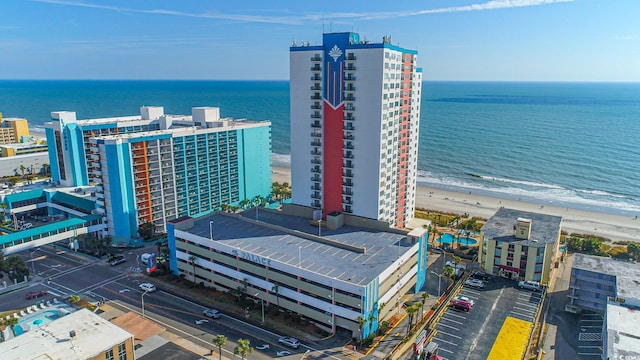 bird's eye view with a water view and a beach view