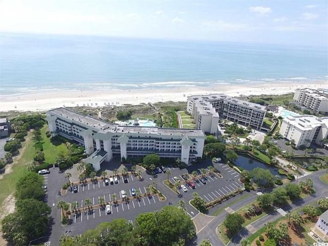 birds eye view of property featuring a beach view and a water view