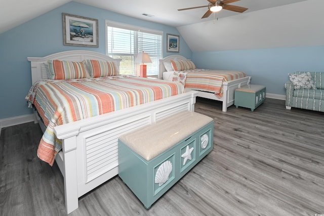 bedroom with ceiling fan, lofted ceiling, and hardwood / wood-style floors