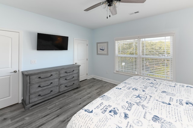 bedroom with dark hardwood / wood-style floors and ceiling fan