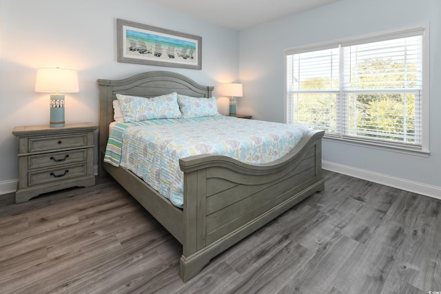 bedroom with dark wood-type flooring