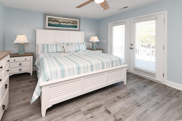 bedroom featuring ceiling fan, wood-type flooring, and access to exterior