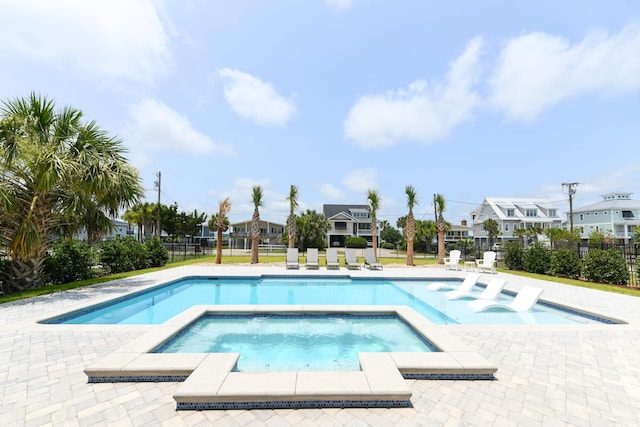 view of swimming pool with an in ground hot tub