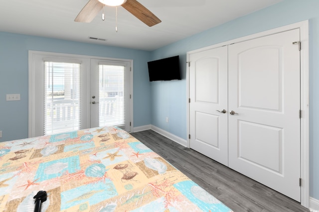 unfurnished bedroom featuring french doors, dark hardwood / wood-style flooring, a closet, ceiling fan, and access to exterior