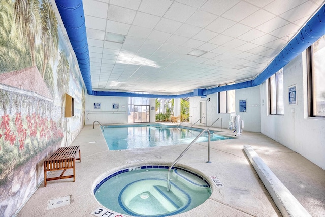 view of swimming pool with an indoor hot tub