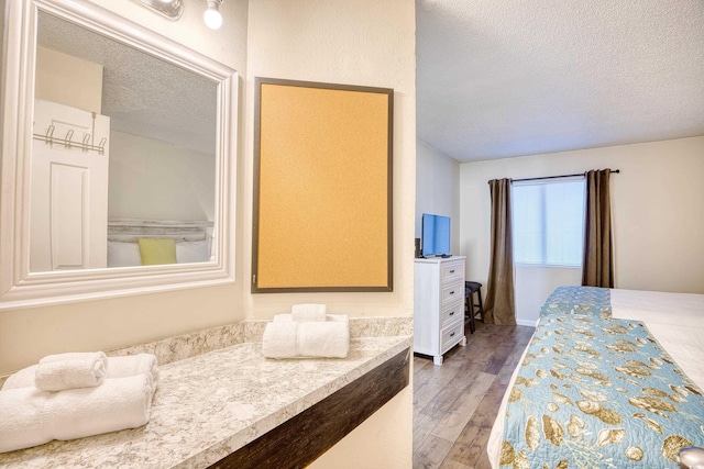 bedroom featuring dark hardwood / wood-style floors and a textured ceiling