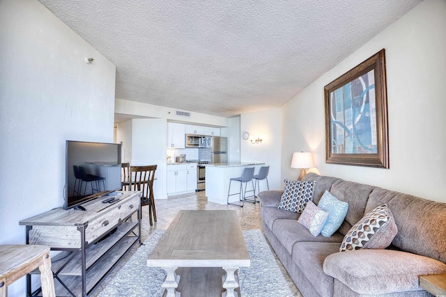 tiled living room with a textured ceiling