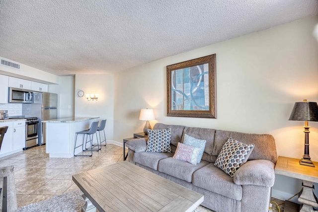 living room with light tile patterned floors and a textured ceiling