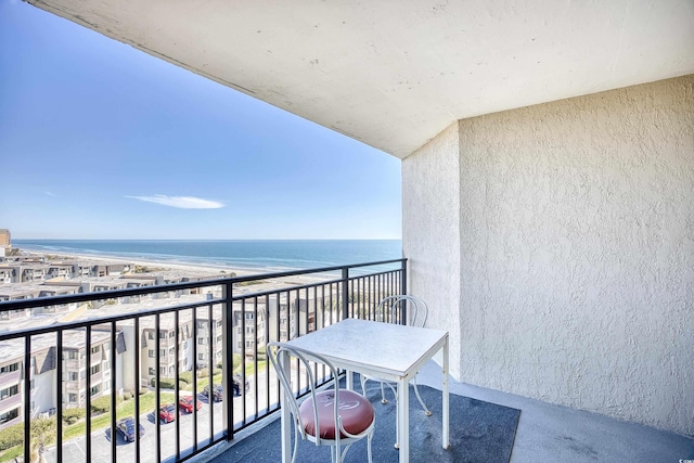 balcony with a water view and a beach view