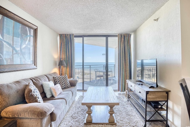 living room with floor to ceiling windows and a textured ceiling