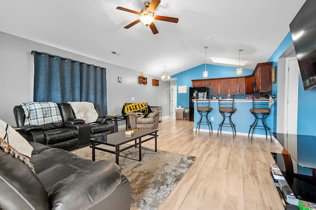 living room with lofted ceiling, light hardwood / wood-style flooring, and ceiling fan