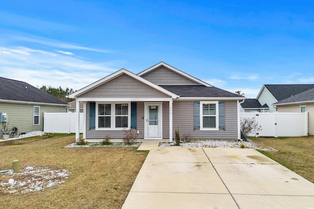 view of front of home with covered porch and a front lawn