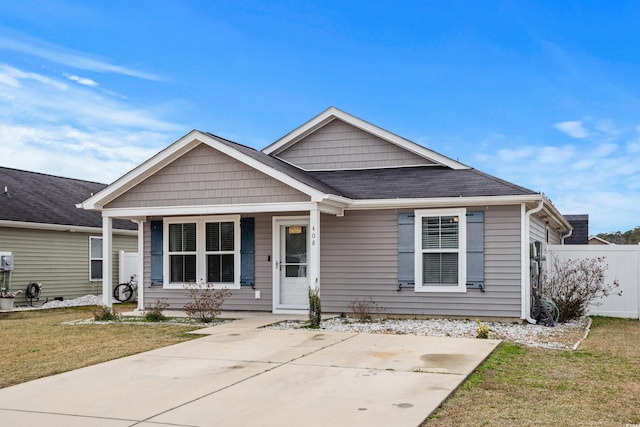 view of front of property with a porch and a front lawn