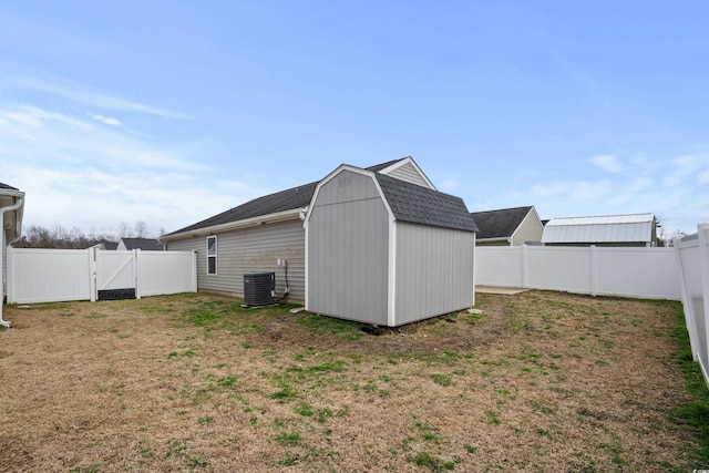 view of outdoor structure featuring central AC and a lawn