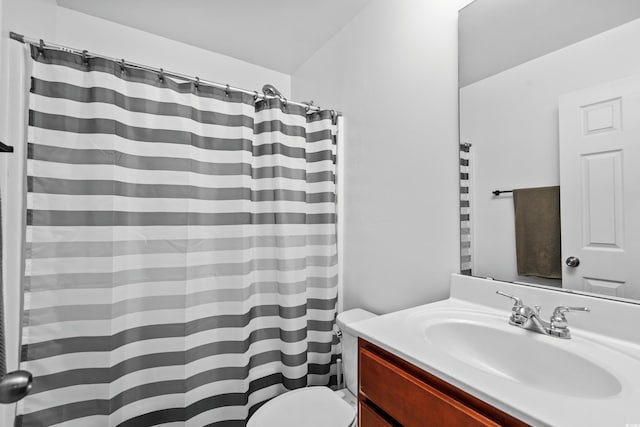 bathroom featuring vanity, a shower with shower curtain, and toilet