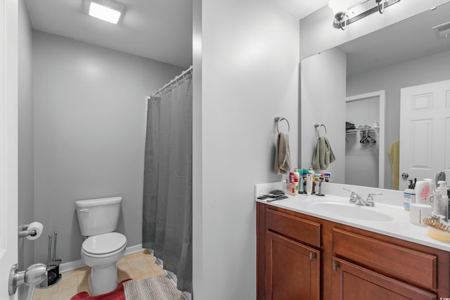 bathroom with vanity, tile patterned floors, and toilet