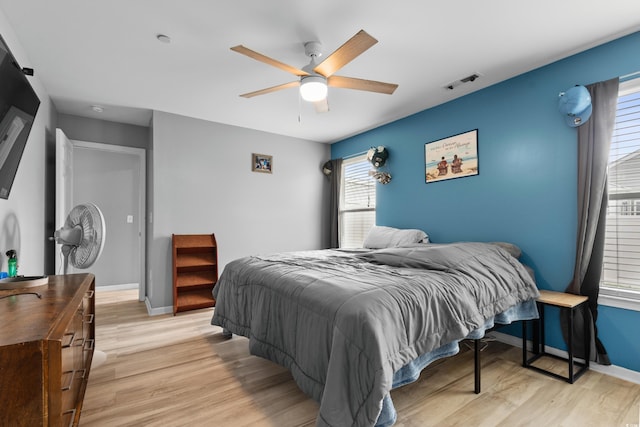 bedroom with ceiling fan and light wood-type flooring