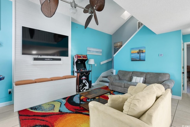 tiled living room with lofted ceiling, a textured ceiling, and ceiling fan