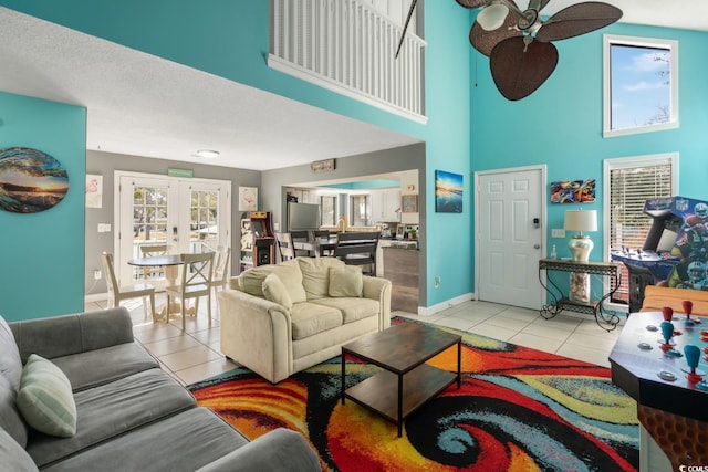 tiled living room with french doors and ceiling fan