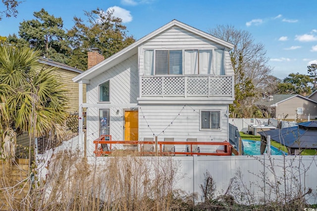 rear view of property featuring a balcony