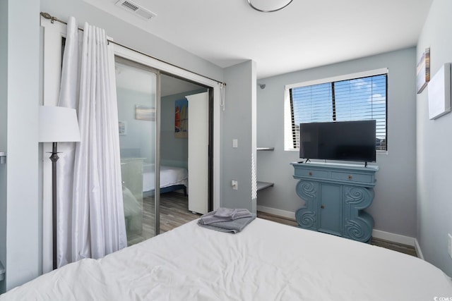 bedroom with hardwood / wood-style flooring and a closet