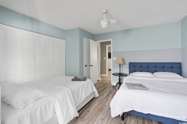 bedroom with hardwood / wood-style flooring, a closet, and ceiling fan