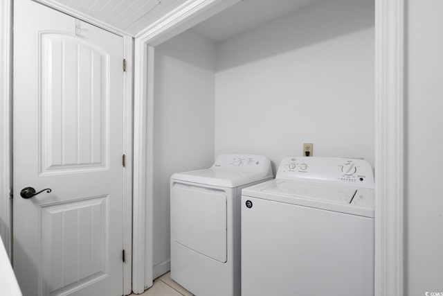 laundry area featuring washer and dryer and light tile patterned floors