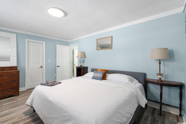 bedroom featuring hardwood / wood-style floors, crown molding, and a textured ceiling