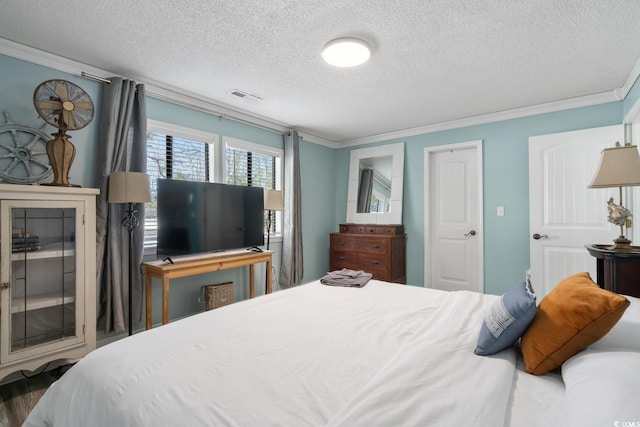 bedroom with ornamental molding and a textured ceiling