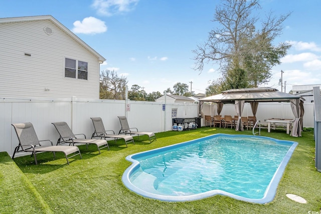 view of swimming pool with a gazebo and a yard