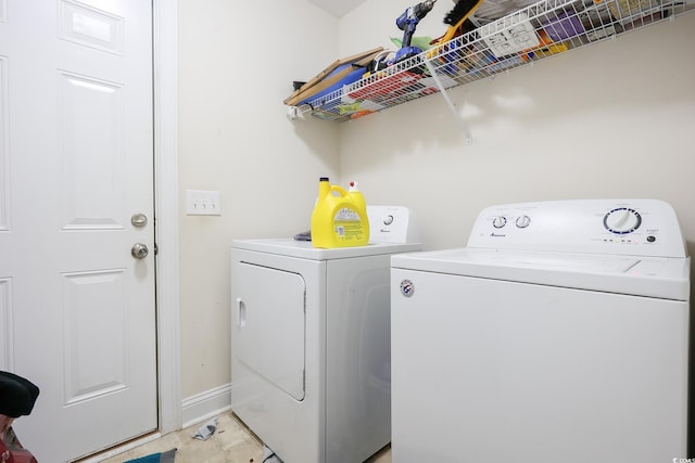 clothes washing area with laundry area, independent washer and dryer, and baseboards