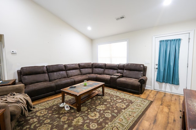 living room featuring vaulted ceiling, wood finished floors, visible vents, and recessed lighting