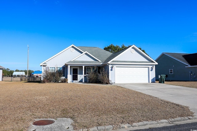 view of front of property with driveway, a garage, roof with shingles, fence, and a porch