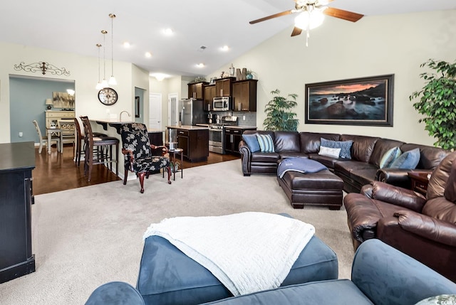 living room with light carpet, vaulted ceiling, and ceiling fan