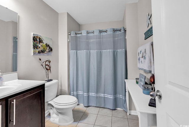 bathroom with vanity, toilet, curtained shower, and tile patterned flooring