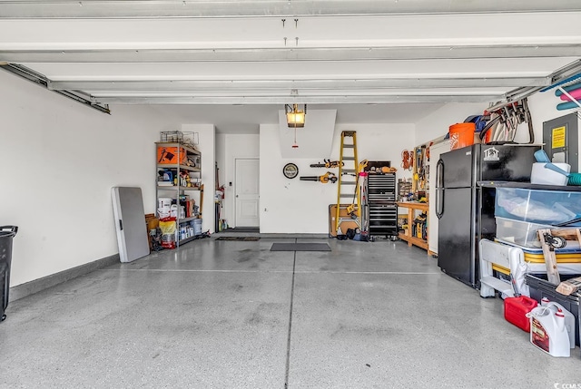 garage featuring a garage door opener and black refrigerator