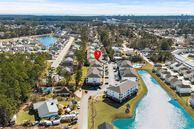 drone / aerial view with a water view and a residential view