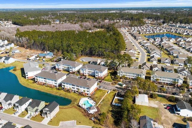 drone / aerial view featuring a residential view and a water view