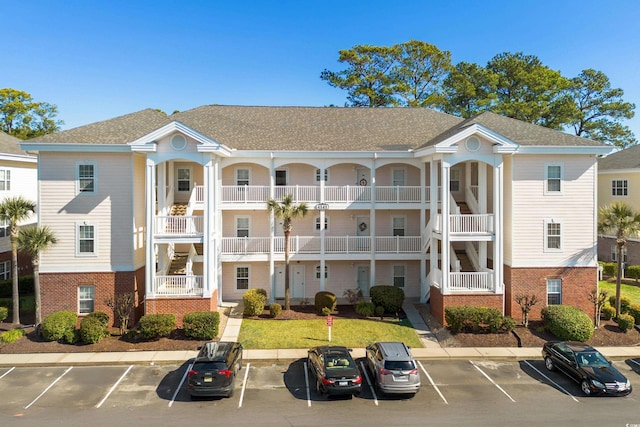 view of building exterior with uncovered parking