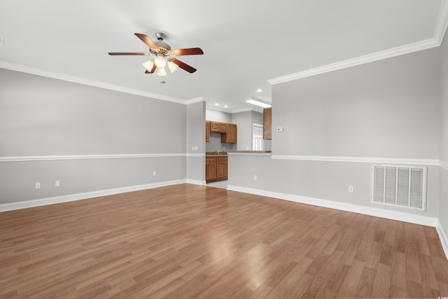 unfurnished living room featuring a ceiling fan, baseboards, visible vents, and light wood finished floors