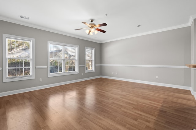 empty room with plenty of natural light, baseboards, and wood finished floors