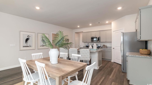 dining room with dark hardwood / wood-style floors